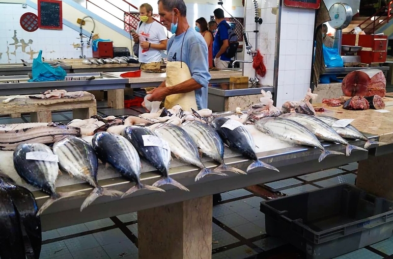 Image: Fish rows in the market. Large carcasses of tuna are spread out on the counter
